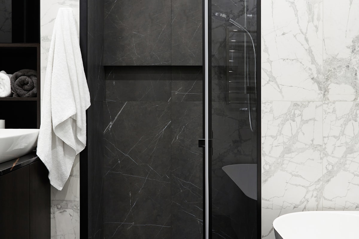Detail from a finished bathroom with marble and black fittings